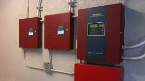 Dual fire alarm control panels mounted on wall